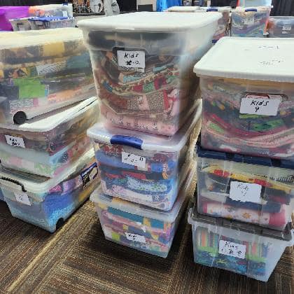 Quilts sorted and packed for distribution night